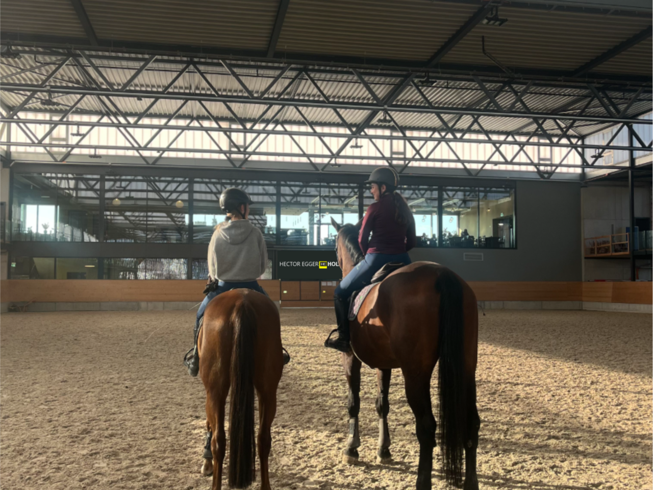 Zwei Reitschülerinnen in der Reithalle